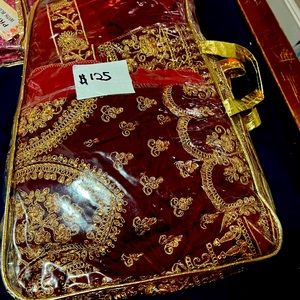 It’s burgundy, comes with side purse and jewelry. Lovely .